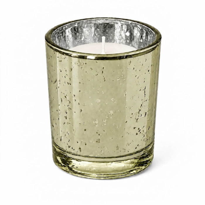 An upscale dining table setup showcasing a burning Metallic Gold Mercury Votive Holder cup