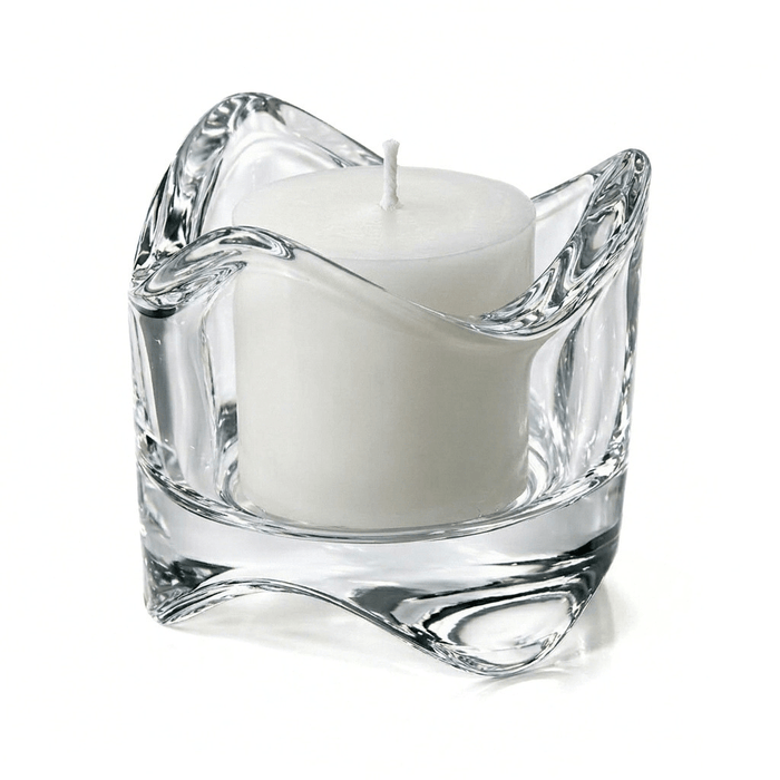 Clear glass swirl-top votive holder with a white candle on a white background