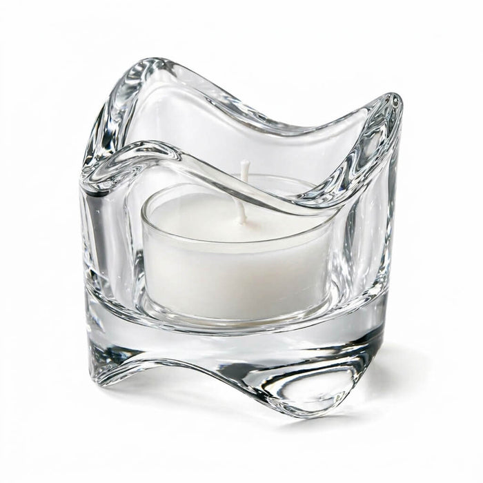 Clear glass swirl-top tealight holder with a white candle on a white background
