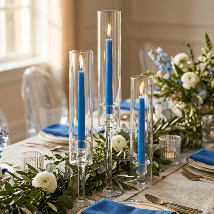 Elegant table setting with blue candles and white floral arrangements