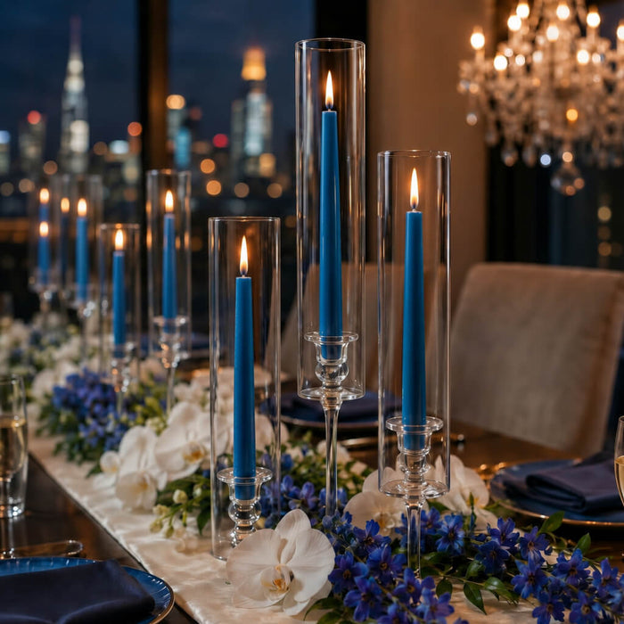 Blue taper candles with floral centerpiece and city view backdrop
