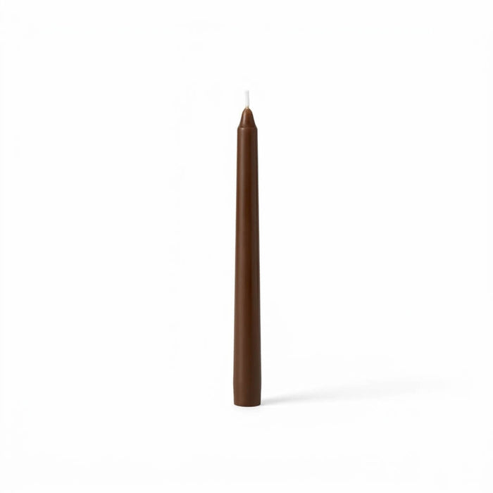 Unlit brown taper candle isolated on white background