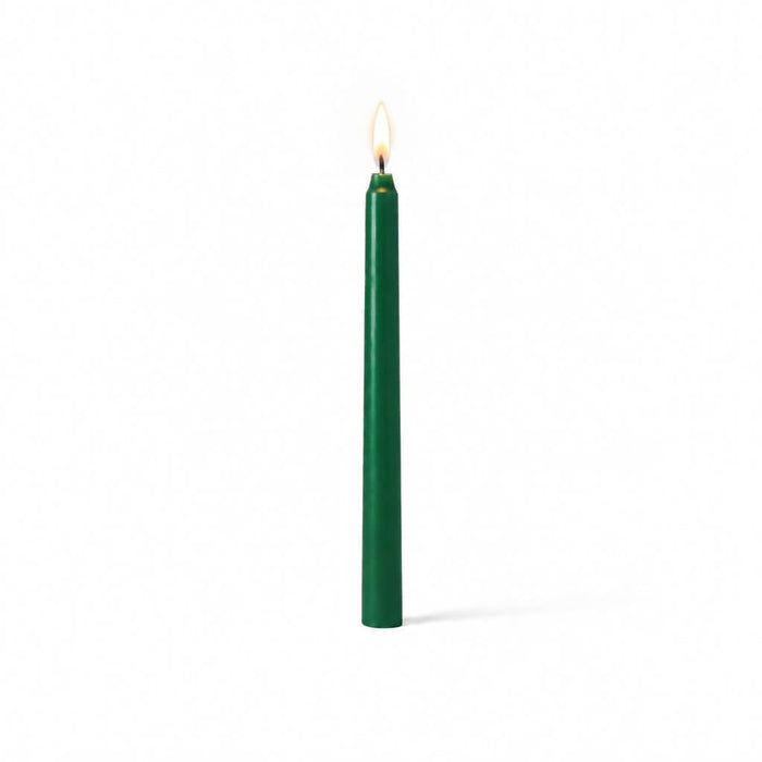 Green taper candle glowing on clean white background