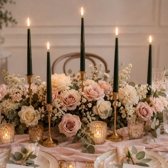 Romantic dinner table with green candles and pastel rose arrangements