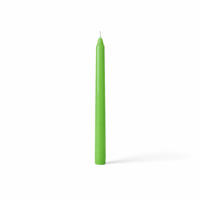 Unlit green taper candle isolated on white
