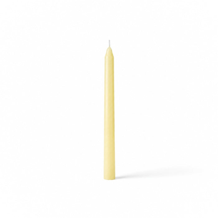 Ivory taper candle isolated on white background