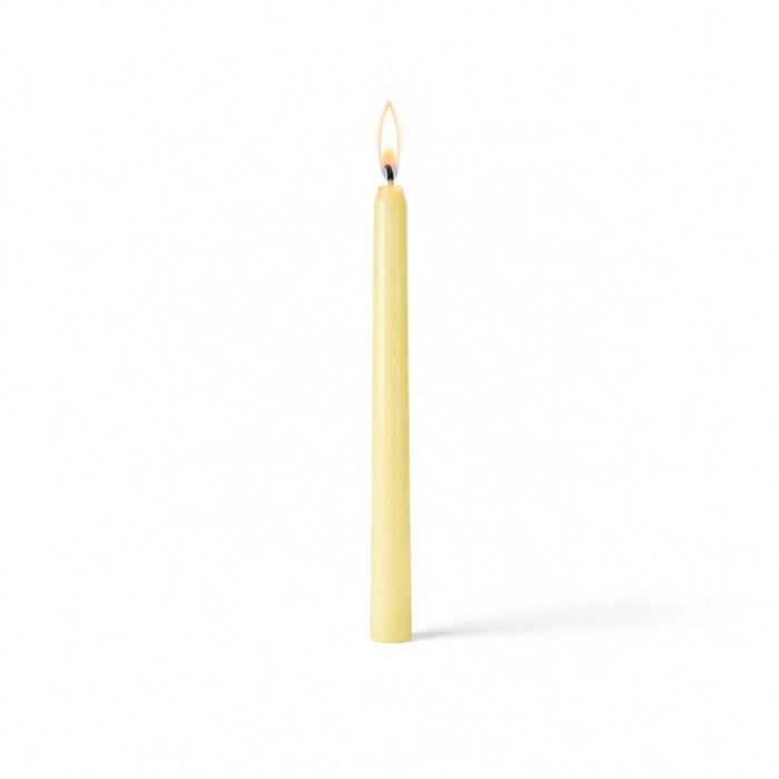 Ivory lit taper candle standing on white background