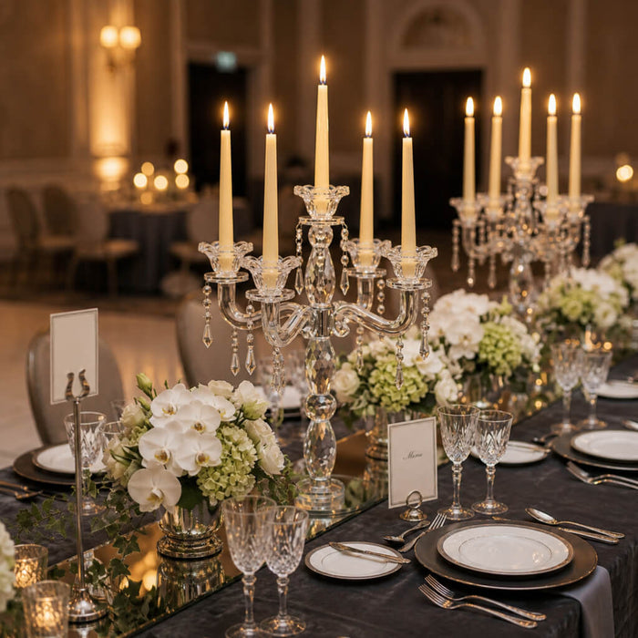 Romantic reception table with ivory candles and lush floral decor