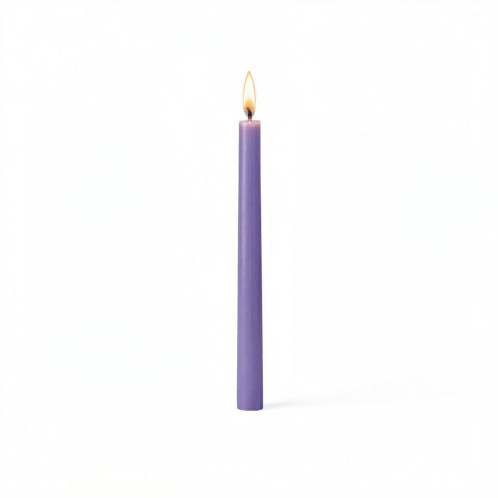 Single lavender taper candle glowing on white surface