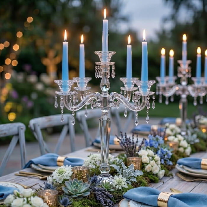 Light blue taper candles on crystal candelabras at elegant outdoor dinner table decor