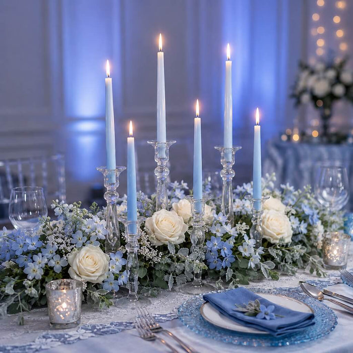 Light blue taper candles on elegant floral centerpiece table decor