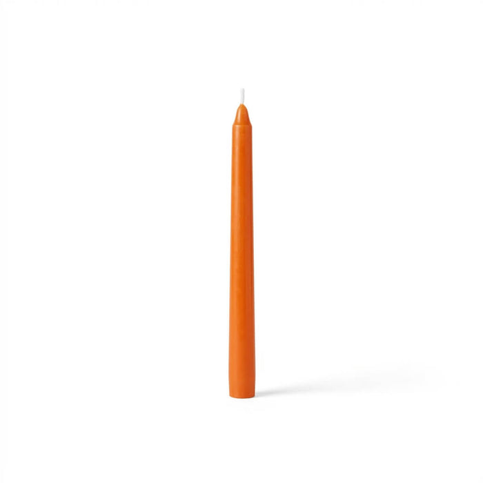 Single orange taper candle on white background