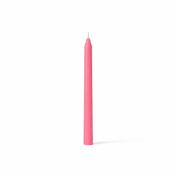Pink taper candle isolated on white background
