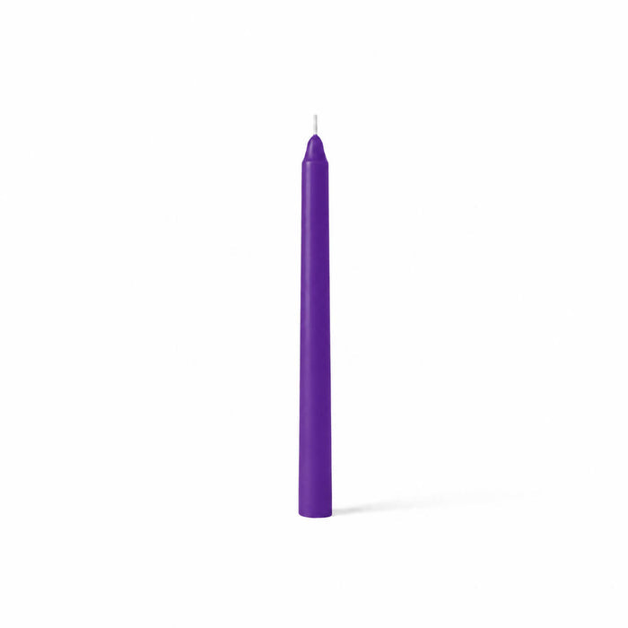 Single purple taper candle on white backdrop