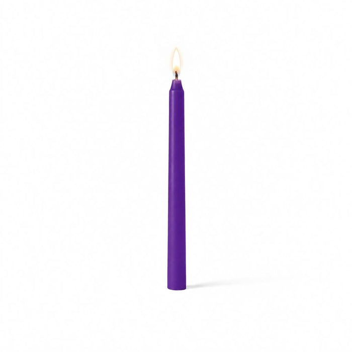 Purple lit taper candle standing on white background