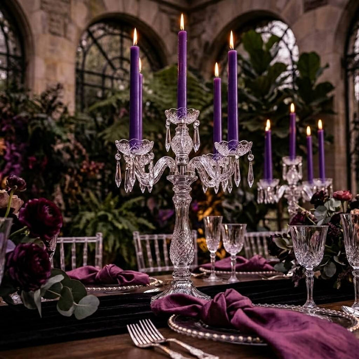 Crystal candle holder with purple taper candles and dark floral decor