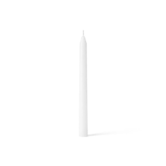 One white taper candle standing on a clean white surface