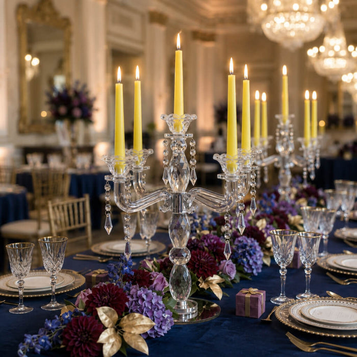 Crystal candelabra with yellow candles and luxurious floral centerpiece