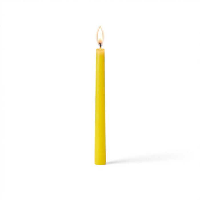 Single glowing yellow taper candle on white surface