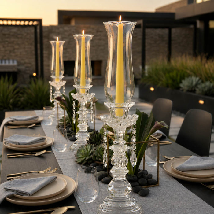 Modern outdoor dining setup with crystal candlesticks and yellow candles