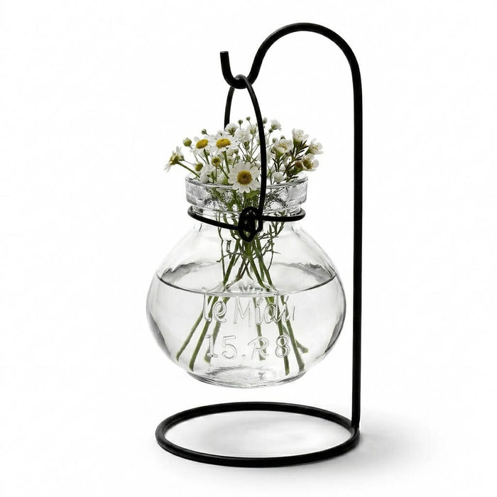 Vintage Jar Hanging Glass Vase with small white flowers on a black metal stand