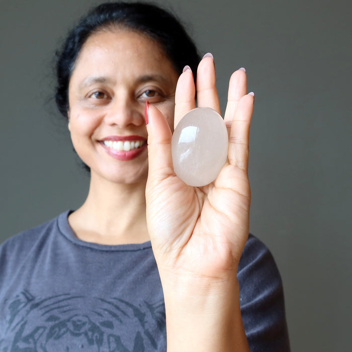 woman holding rutilated quartz egg