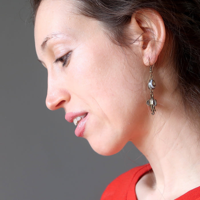 female model wearing sardonyx elephant earrings