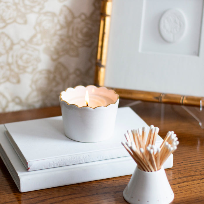 Scallop Soy Candle Cup in Gold-Luster Stoneware — lit candle beside a separately sold match striker and frame; Susan Gordon Pottery