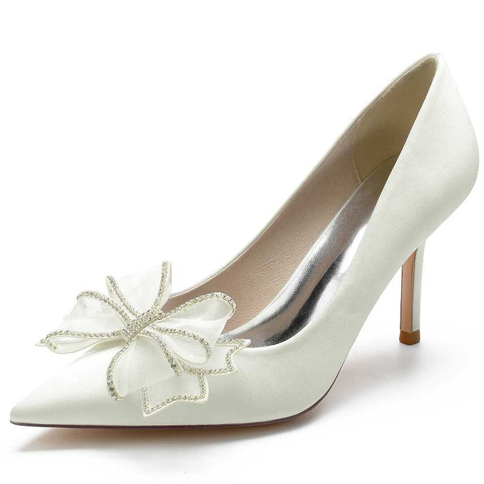 Elegant white satin prom heels for women with a decorative bow and pointed toe design