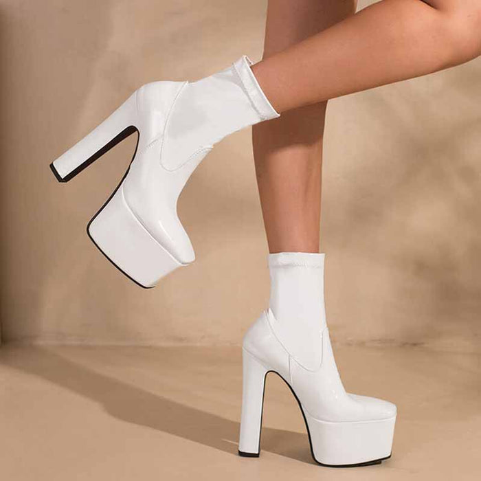 Stylish women's platform ankle boots with a sleek white design and trendy high heel