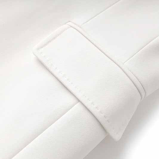 Detail of women's white pantsuit set featuring elegant cuff design in soft fabric