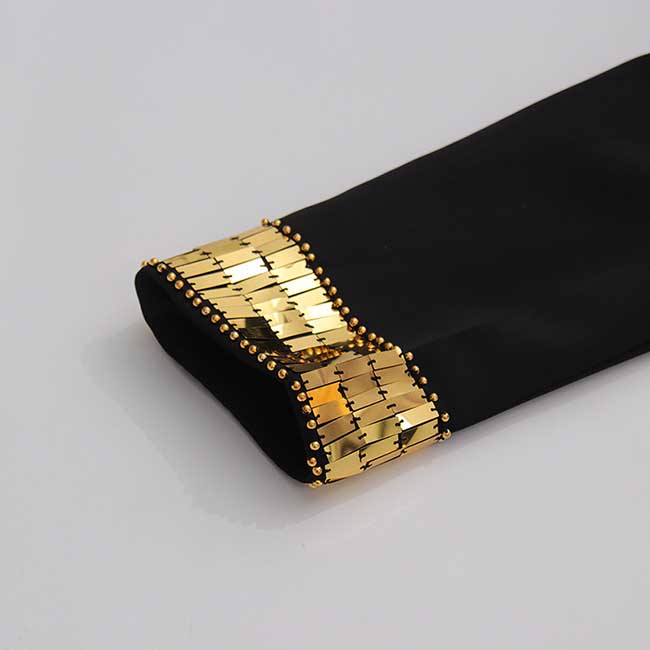 Close-up of evening sequin blazer jacket sleeve detailing with gold embellishments