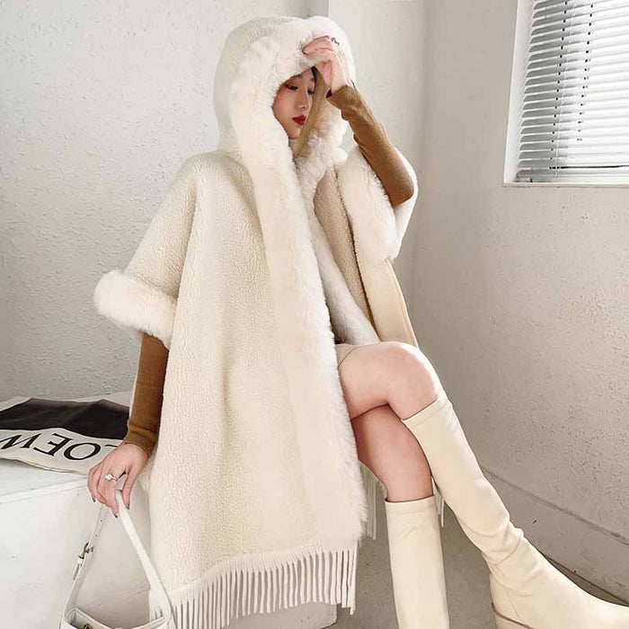 Women's fur collar poncho by S&DCo, featuring a cozy hood and elegant fringe detail