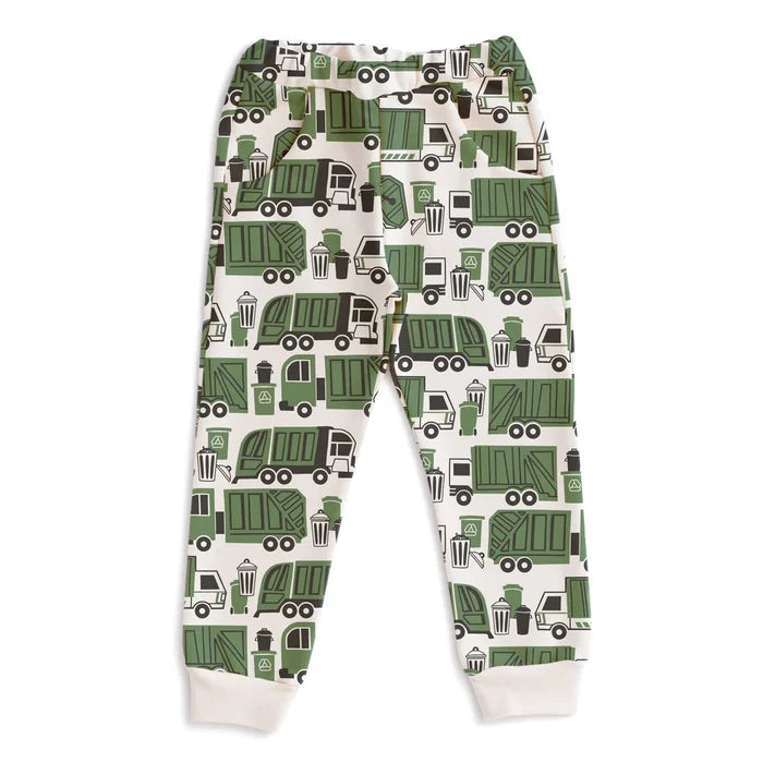 A pair of children's jogger pants with an all-over green garbage truck pattern on a cream background, featuring ribbed cuffs at the ankles.