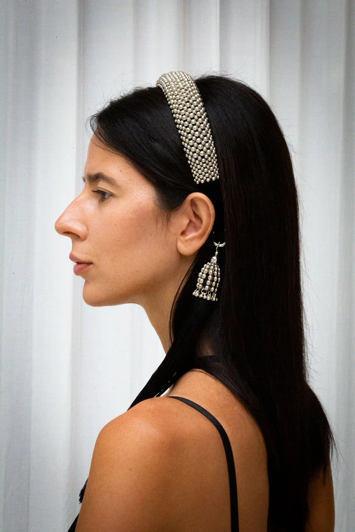 woman wear Teuta Headband silver with trinity medallions in neutral background by object & dawn showing side profile