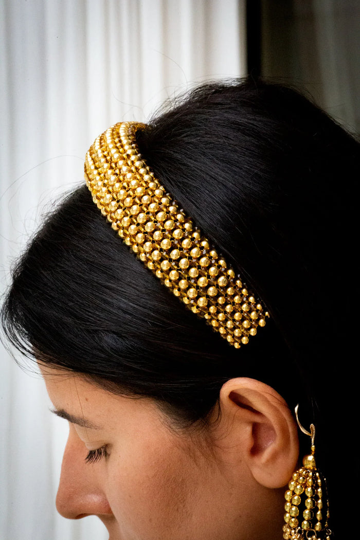 Gold beaded Teuta headband worn by a person with a neutral background by Object & Dawn