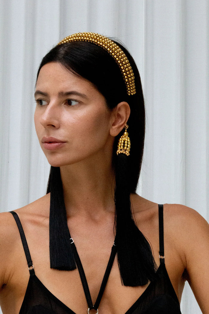 Woman with black  outfit wear Beaded Teuta Headband in gold by Object & Dawn in neutral bankground