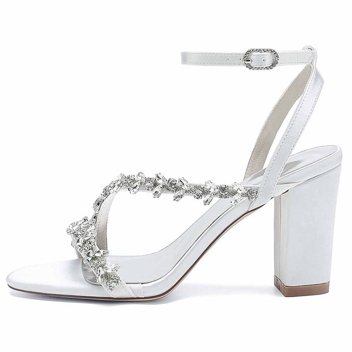 Elegant white block heels sandals with decorative embellishments and ankle strap for special occasions