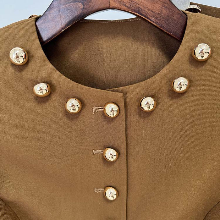 Close-up of women's brown tailored pantsuit featuring gold button details for a sophisticated look