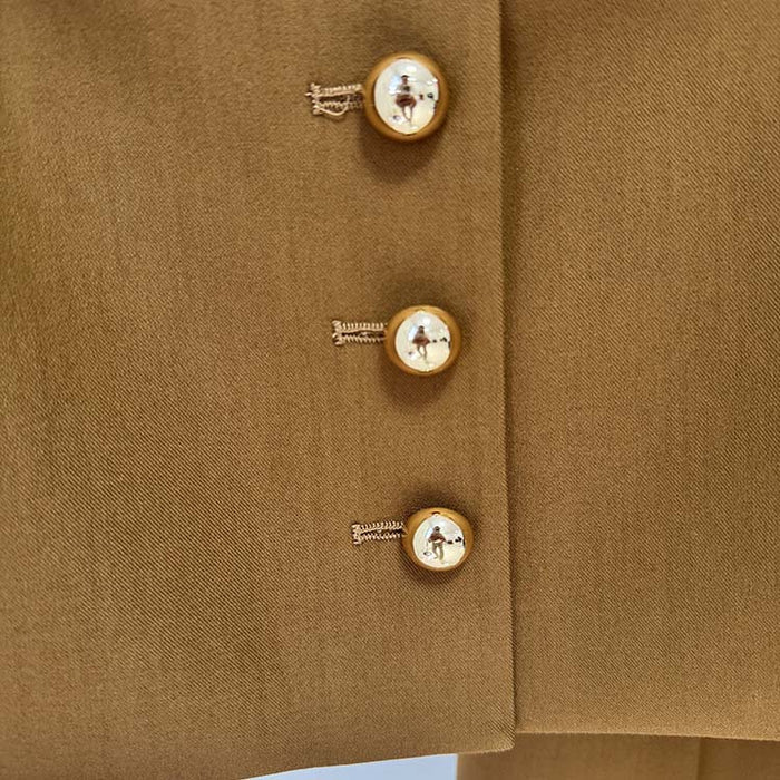 Close-up of SD Dresscode women's brown tailored pantsuit featuring elegant gold buttons for a chic look