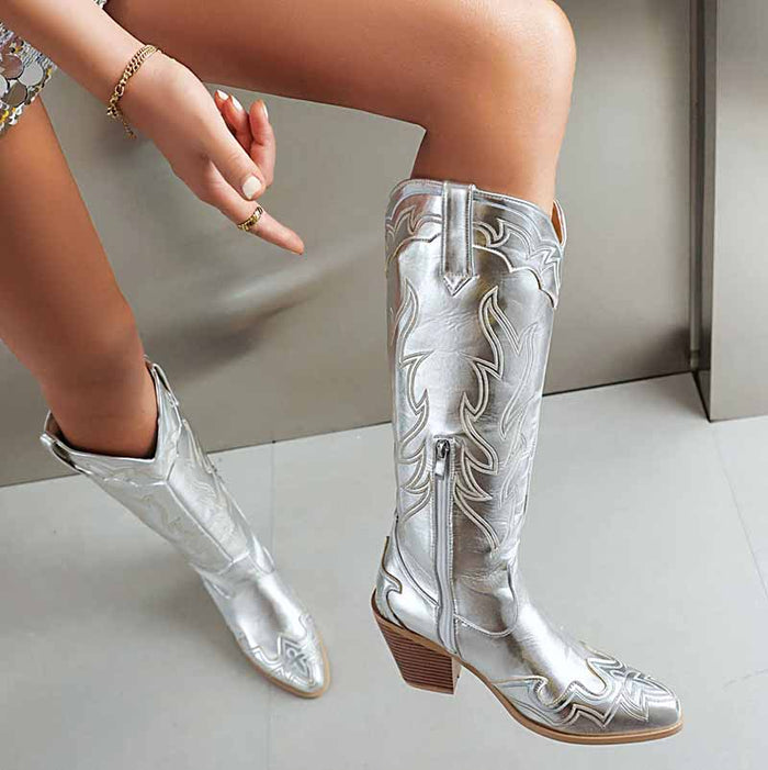 Stylish women's knee high cowboy boots in silver with intricate detailing for a modern look