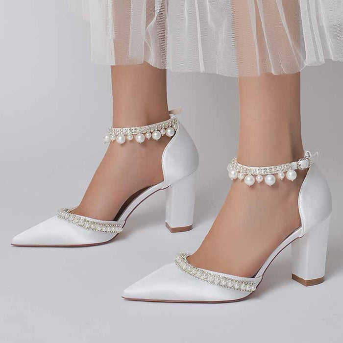 Elegant women's white block heel wedding shoes adorned with pearl details for bridal style